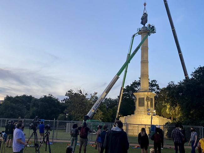 People gather in Marion Square in the historic South Carolina city of Charleston to watch the removal of a statue of former vice-president and slavery advocate John C. Calhoun. Picture: AP