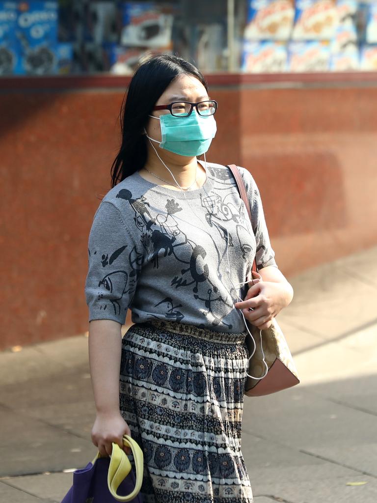 As smoke from bushfires engulfs Sydney, morning commuters are pictured wearing face masks as they make their way to work. Picture: MATRIX