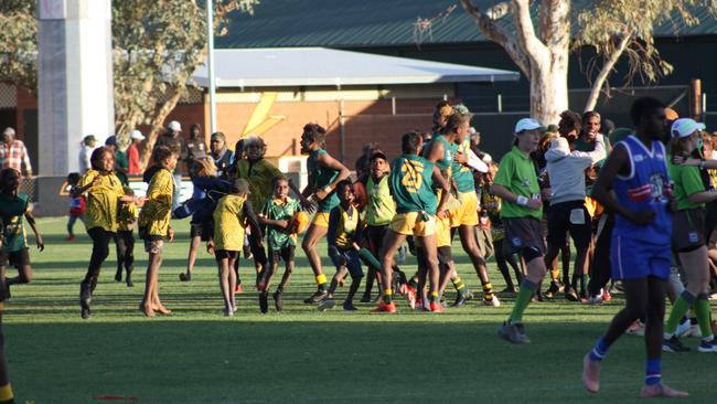 Hundreds run onto Traeger oval to celebrate the Eagles’ win. Picture: Lee Robinson