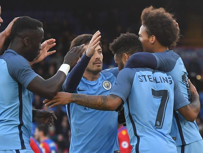 Raheem Sterling (2R) celebrates scoring the opening goal with teammates.