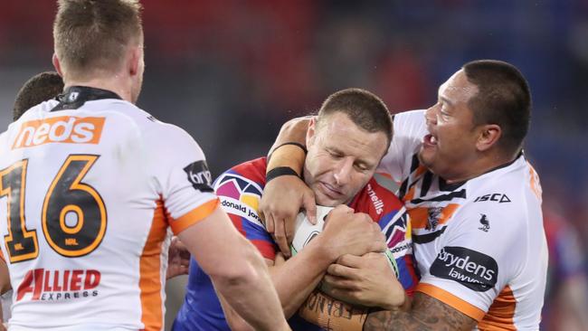 NEWCASTLE, AUSTRALIA - AUGUST 08: Blake Green of the Newcastle Knights is tackled by Joseph Leilua of Wests Tigers during the round 13 NRL match between the Newcastle Knights and the Wests Tigers at McDonald Jones Stadium on August 08, 2020 in Newcastle, Australia. (Photo by Ashley Feder/Getty Images)