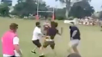 The fight between rival spectators spilt from the grandstand onto the field at the Under-13s rugby league game in Brisbane on Sunday. Picture: Supplied