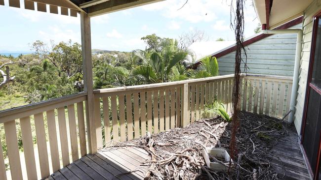 Photographs obtained by Qweekend show vines sprouting from guttering, palms littering the deck and exposed insulation through a hole in the ceiling at the old Great Keppel Island resort.