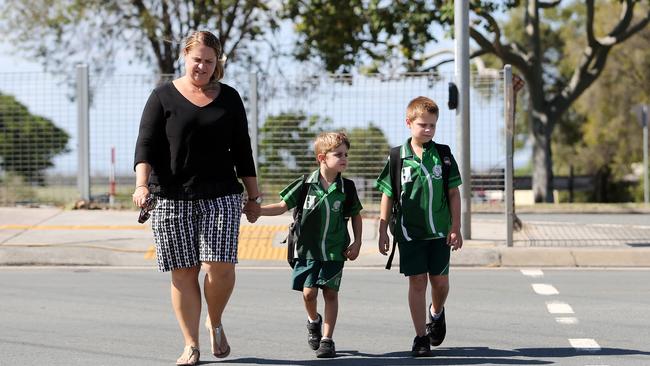 Richelle MacArthur with Oliver and Lincoln use the crossing near Hercules Road State School. Picture: Josh Woning.