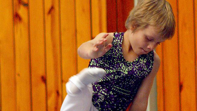 Cassiel Rousseau as a child on the gymnastics mat. 