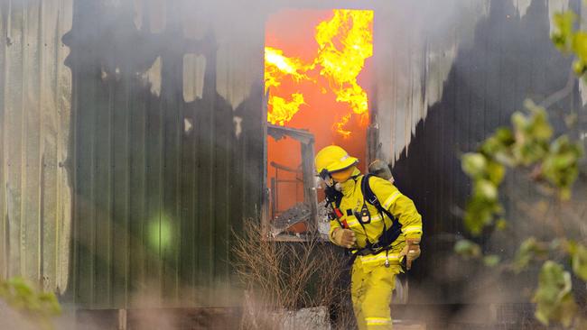 Firefighters battle a house fire in the Kulaluk Aboriginal community in Coconut Grove on November 1, 2014 which killed three people.