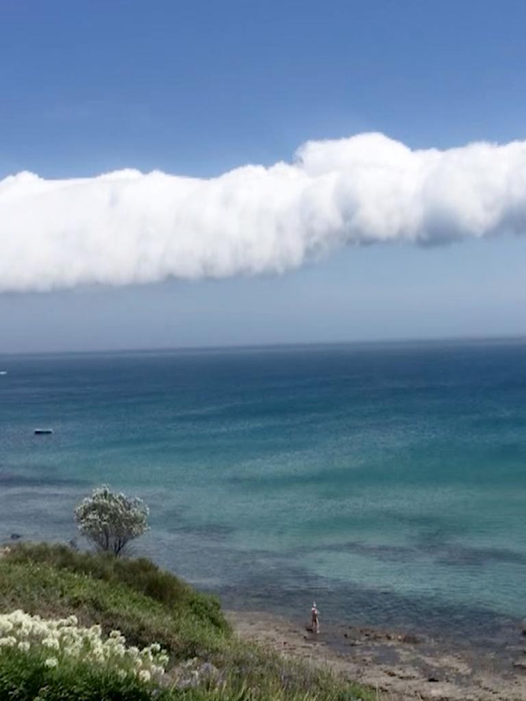 The slim band of cloud rolled over the ocean.