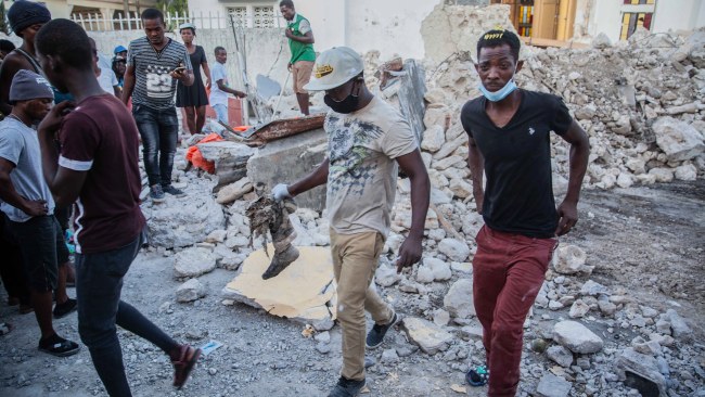 Haitians begin the work of recovering what materials can be after a 7.2-magnitude earthquake struck in Les Cayes, Haiti. Picture: Getty Images