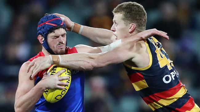 Melbourne's Angus Brayshaw tangles with Adelaide’s Reilly O'Brien at Adelaide Oval. Picture: Sarah Reed