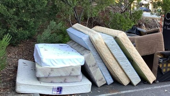 Mattresses and furniture next to charity bins. Picture: Supplied.