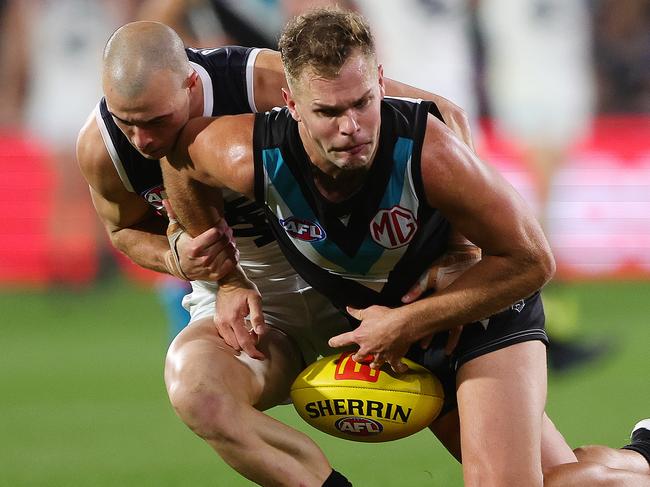 ADELAIDE, AUSTRALIA - MAY 30: Dan Houston of the Power is tackled by Alex Cincotta of the Blues during the 2024 AFL Round 12 match between the Port Adelaide Power and the Carlton Blues at Adelaide Oval on May 30, 2024 in Adelaide, Australia. (Photo by Sarah Reed/AFL Photos via Getty Images)