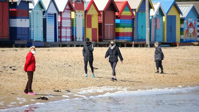 People exercise on Brighton Beach this week. Picture: Ian Currie