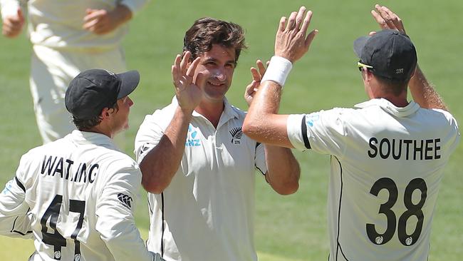 Colin de Grandhomme, centre, is congratulated by team-mates after dismissing Joe Burns. Picture: AAP