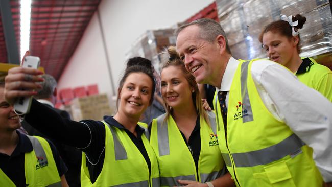 Bill Shorten poses for a selfie with workers at Australian Container Freight Services in Brisbane on Thursday. Picture: AAP 