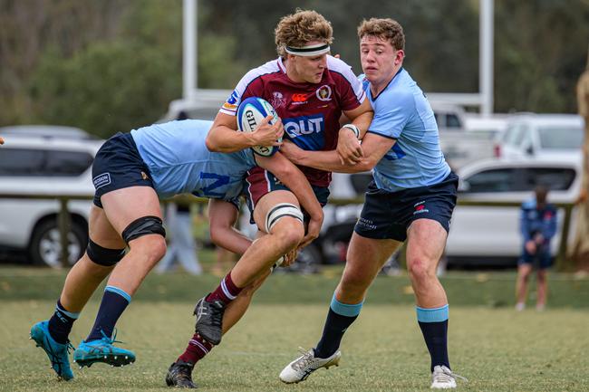 Bond University lock Fergus Gillan runs the ball for the Reds under-19s.