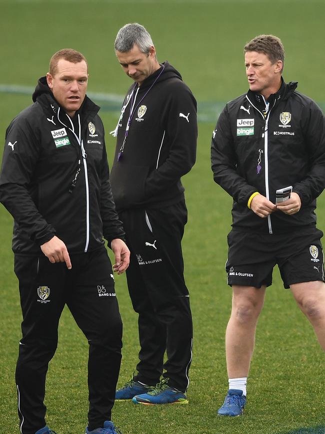 Damien Hardwick (right) talks with assistant coaches Justin Leppitsch and Blake Caracella.