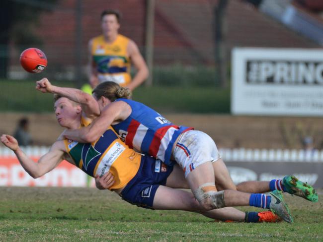 Central District’s Nick Holman tackles the Eagles’ Joseph Sinor during the Bulldogs’ gutsy triumph at Woodville Oval. Picture: AAP Image/Brenton Edwards