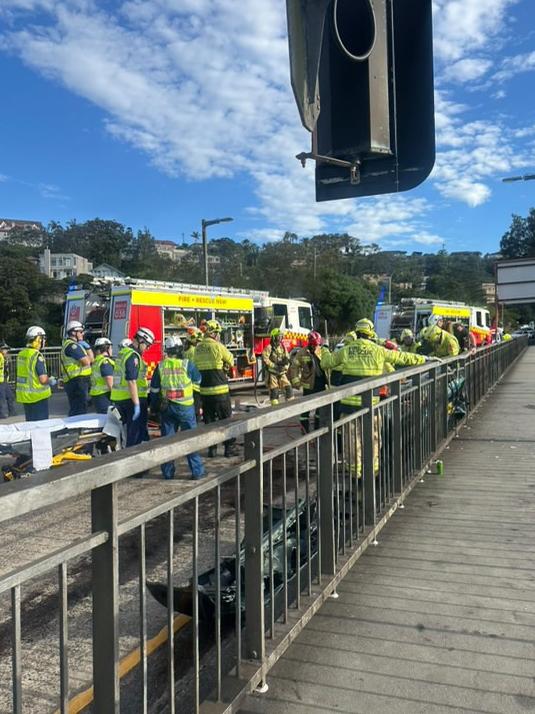 Emergency services work on the injured motorist, Picture: www.mosmancollective.com