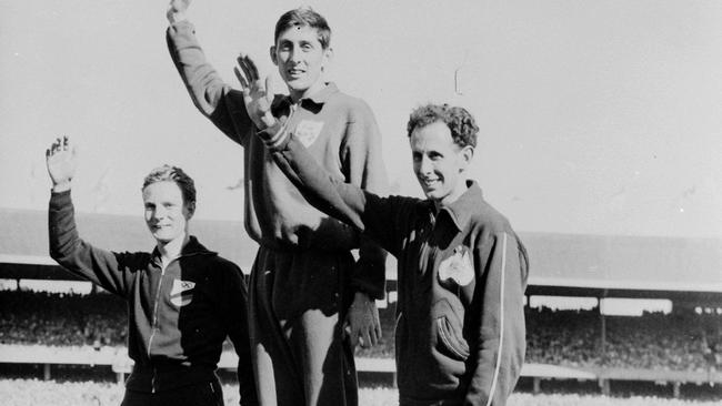 Men’s 1500m medal winners wave to the crowd. Ron Delany of Ireland in the centre. Klaus Richtzenhain of Germany on the left, and John Landy of Australia on the right at the 1956 Olympic Games. Melbourne Olympics. Melbourne Olympic Games.