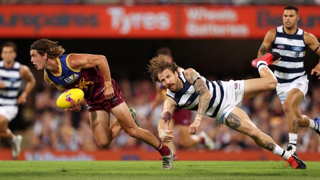 Jarrod Berry the Lions gives Zach Tuohy the slip. Picture: Michael Klein