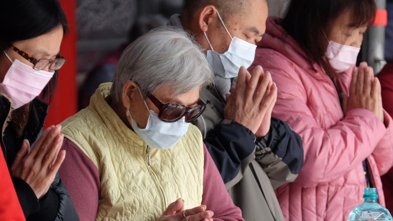 Devotees wearing protective masks pray at the Lungshan temple during the fourth day of the Lunar New year of the Rat in Taipei. Picture: AFP