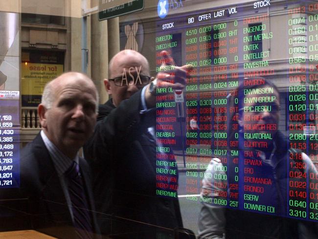 Investors look at stocks on electronic stock boards at the Australia Securities and Exchange (ASX) headquarters in Sydney, Australia, on Tuesday, Sept. 9, 2011. Photographer: Sergio Dionisio/Bloomberg