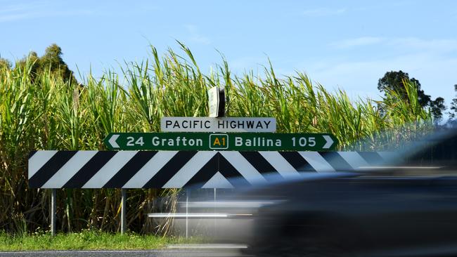 A vehicle passes road signage on the Pacific Highway between Ballina and Grafton. Picture: AAP Image/Dave Hunt