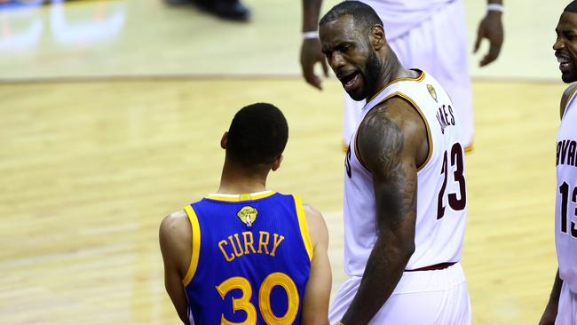 LeBron James stares down Stephen Curry.