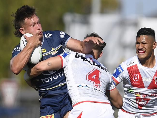 Reuben Cotter of the Cowboys is tackled by Zac Lomax of the Dragons during the round 24 NRL match between the St George Illawarra Dragons and the North Queensland Cowboys at Browne Park. (Photo by Ian Hitchcock/Getty Images)