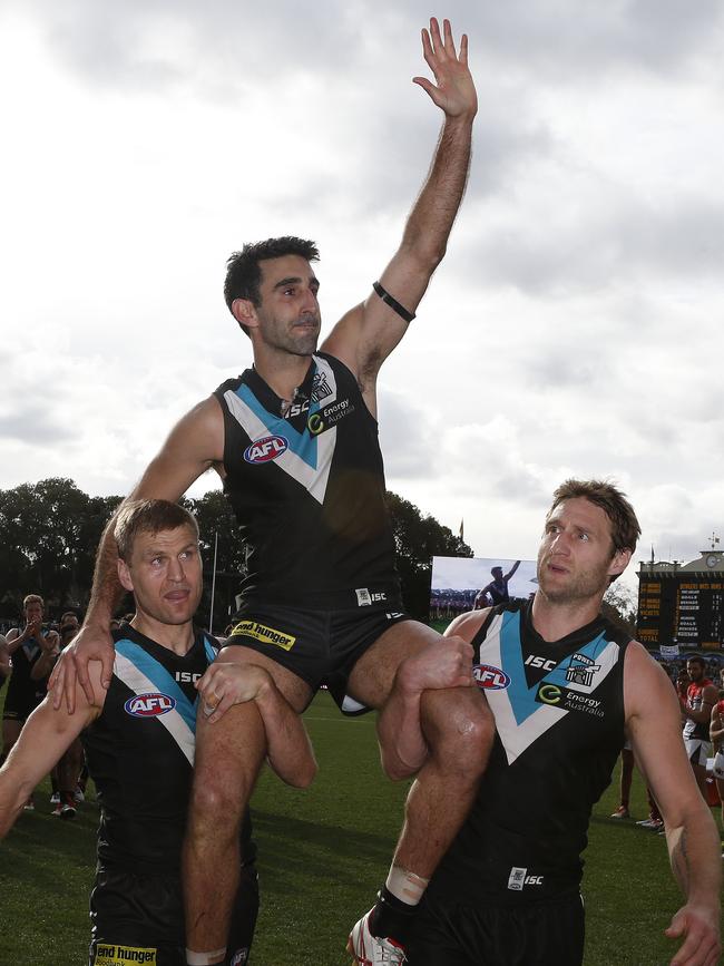 Kane Cornes and Jay Schulz chair Dom Cassisi from the field. Picture: Sarah Reed.