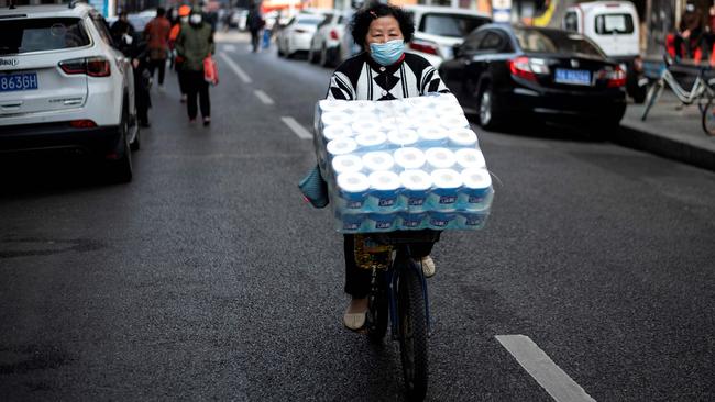 Collecting the essentials on the streets of Wuhan. Picture: AFP