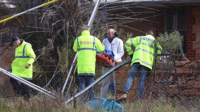 Police remove remains believed to be that of Robert Atkins from a water tank in the state’s Mid North. Picture: Riley Walter