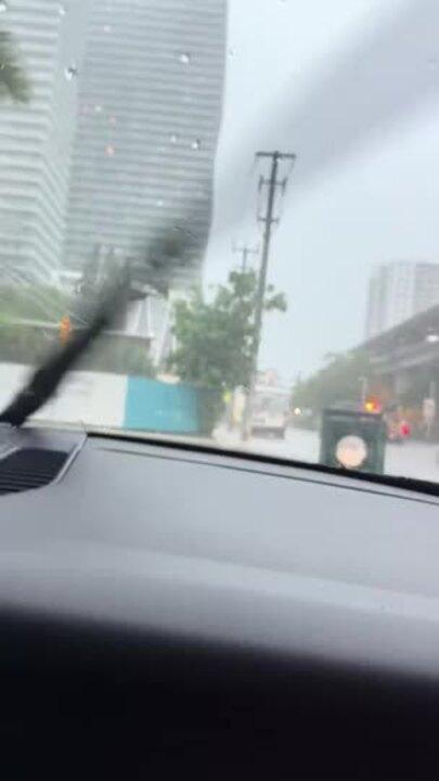 Cars and Scooters Traverse Inches of Floodwater in Miami