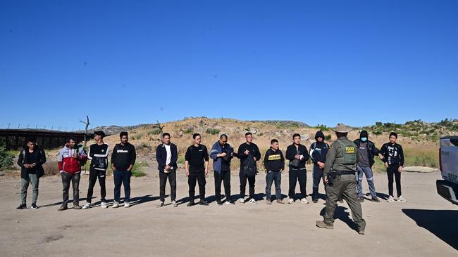 Chinese migrants, including three from Bangladesh, line up at Jacumba Hot Spring, California, on June 6, 2024, after crossing the US-Mexico border overnight. Picture: AFP