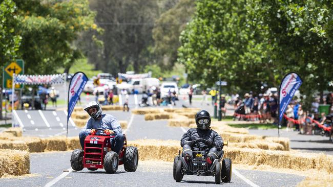 Josh Darr (left) in his Massey-Fergie kart races against Batman aka Doug Gale in the Greenmount Billy Kart Challenge, Saturday, November 23, 2024. Picture: Kevin Farmer