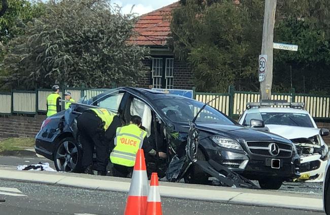 Investigators inspecting the crashed Mercedes. Picture: Eliza Barr