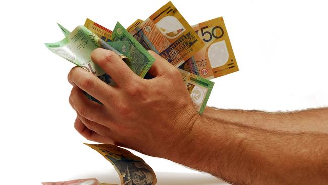 Australian cash money notes scrunched in hands.