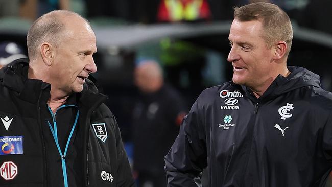 ADELAIDE, AUSTRALIA - MAY 30: Ken Hinkley, Senior Coach of the Power talks to Michael Voss, Senior Coach of the Blues during the 2024 AFL Round 12 match between the Port Adelaide Power and the Carlton Blues at Adelaide Oval on May 30, 2024 in Adelaide, Australia. (Photo by James Elsby/AFL Photos via Getty Images)