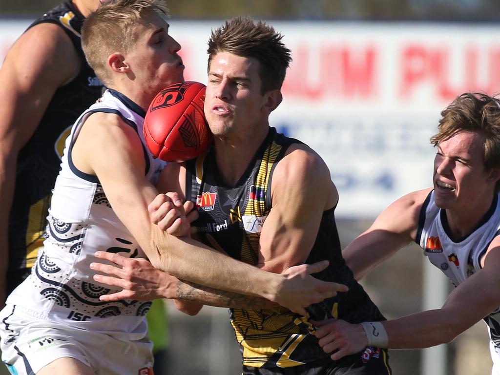 SANFL: Glenelg v South Adelaide at Glenelg Oval. Glenelg's Elliott Chalmers caught between South's Coby Helyar (L) and Cody Szust. Pic. Dean Martin