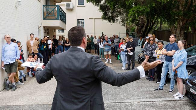 DAILY TELEGRAPH. Property. Auctioneer Chris Scerri takes bids for 8/1 Chandos Street in Ashfield, a 3 bedroom apartment in a historic former hospital building. Saturday 02/11/2024. Picture by Max Mason-Hubers