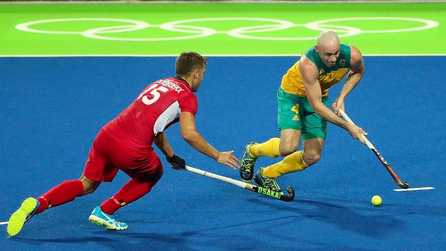 Glenn Turner of Australia moves the ball past Emmanuel Stockbroekx of Belgium.