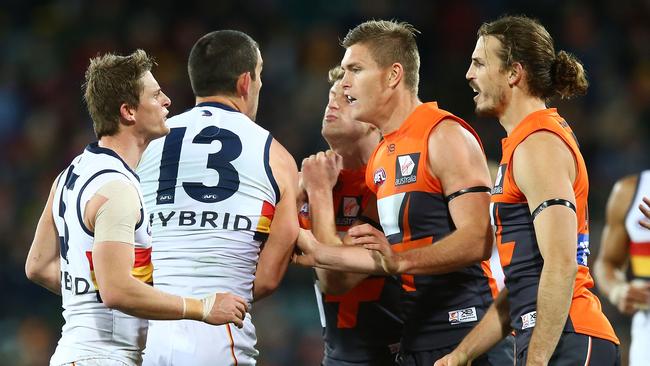 Matt Crouch of the Crows and Phil Davis of the Giants clash after a tackle on Josh Kelly of the Giants . Picture: Mark Nolan/Getty Images