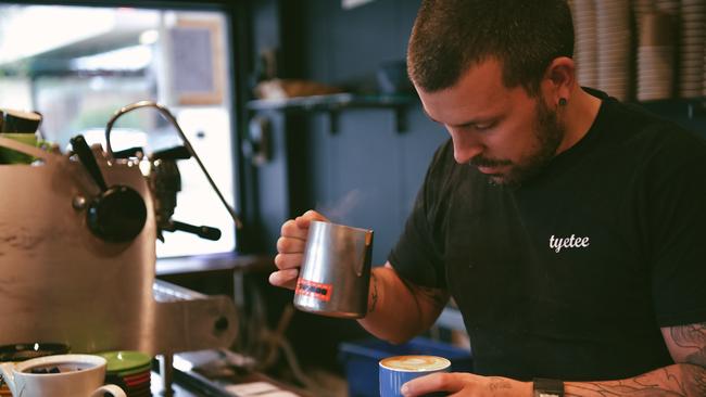 A barista pours coffee in Adelaide. Picture: AAP