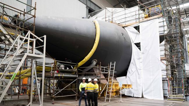 Workers stand by a Collins-class submarine at Adelaide’s Osborne shipyard. Picture: NCA NewsWire / Morgan Sette