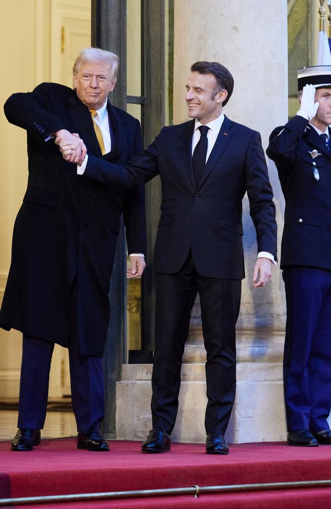 US President-elect Donald Trump gives French President Emmanuel Macron an awkward ‘power handshake’ on the steps of the Elysee Palace in Paris. Picture: Getty Images