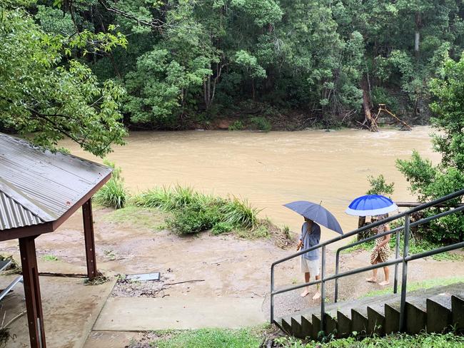 James and Megan Dunn from Tugun check out Currumbin Creek Currumbin Valley Rock Pools after it flooded due to torrential rain over night causing the creek to break its banks and cause damage to Gold Coast Council BBQ facilities and tables when large logs and debris collided with it. NCA NewsWire / Scott Powick