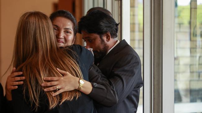 Calvin Wijeweera’s mum Anoma and dad Sandun embrace mourners. Picture: Justin Lloyd