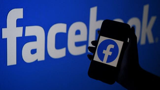 A smart phone screen displays the logo of Facebook on a Facebook website background in Arlington, Virginia. Pic: AFP