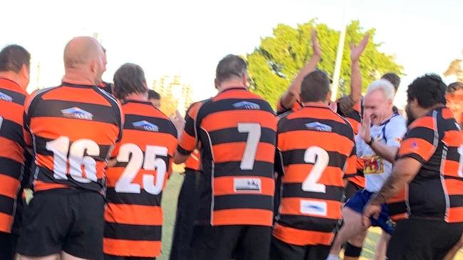 Coomera Crushers players form a guard of honour for retiring referee Rod Thompson.