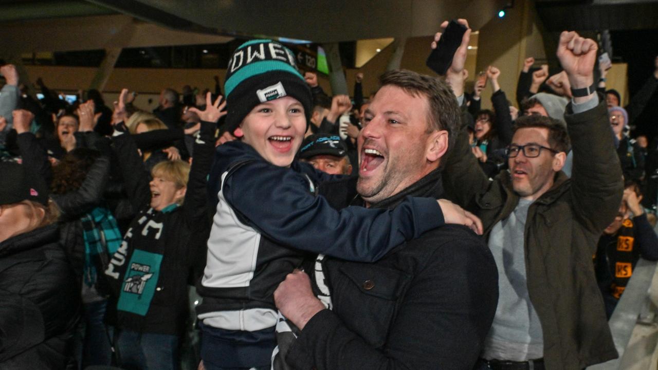 SEPTEMBER 13, 2024: Daniel and Oliver 6yo Hardy celebrate Port defeating Hawthorn after the semi final at Adelaide Oval. Picture: Brenton Edwards